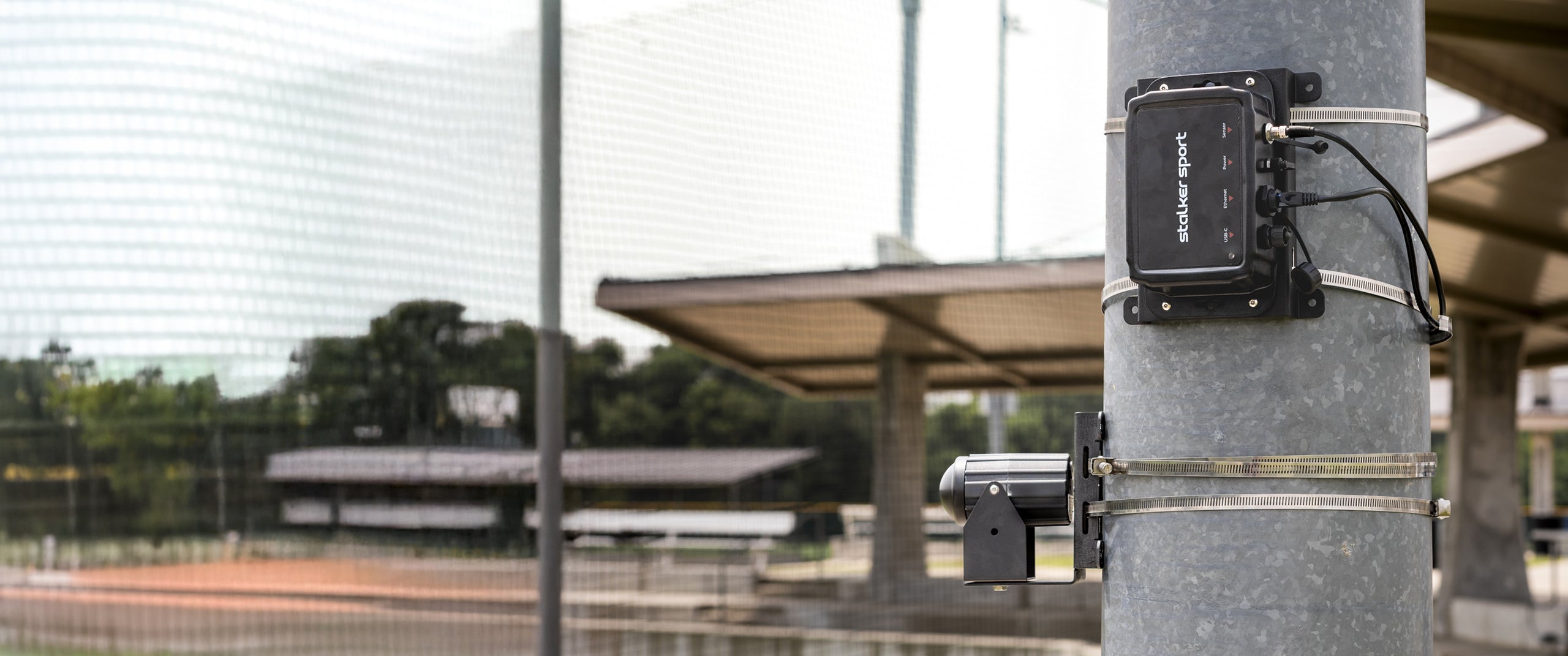 Stalker Sport Sensor 3s and Stadium Hub attached to pole in baseball field.