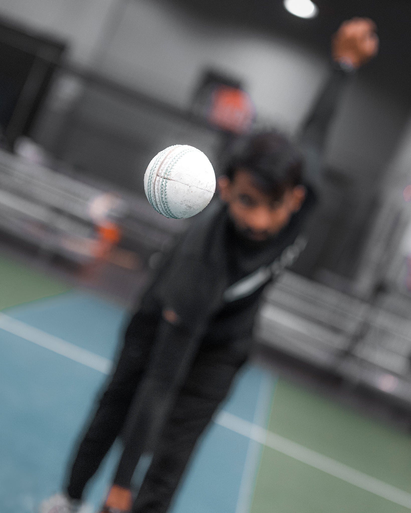 A bowler pitching a cricket ball.