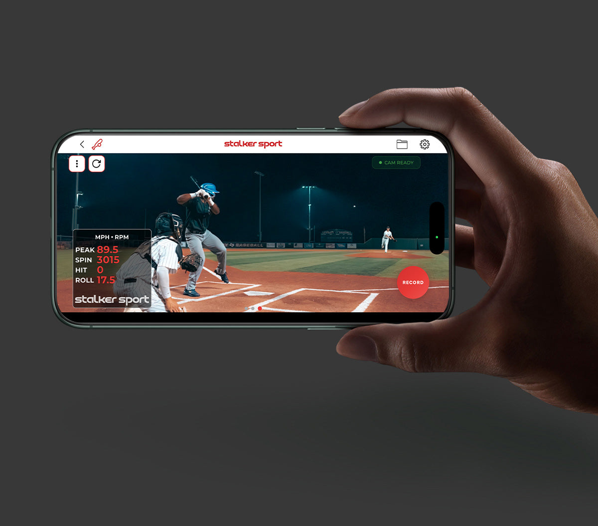 A hand holding a phone showing the video mode of the Stalker Sport Radar iOS app showing 3 people playing baseball.