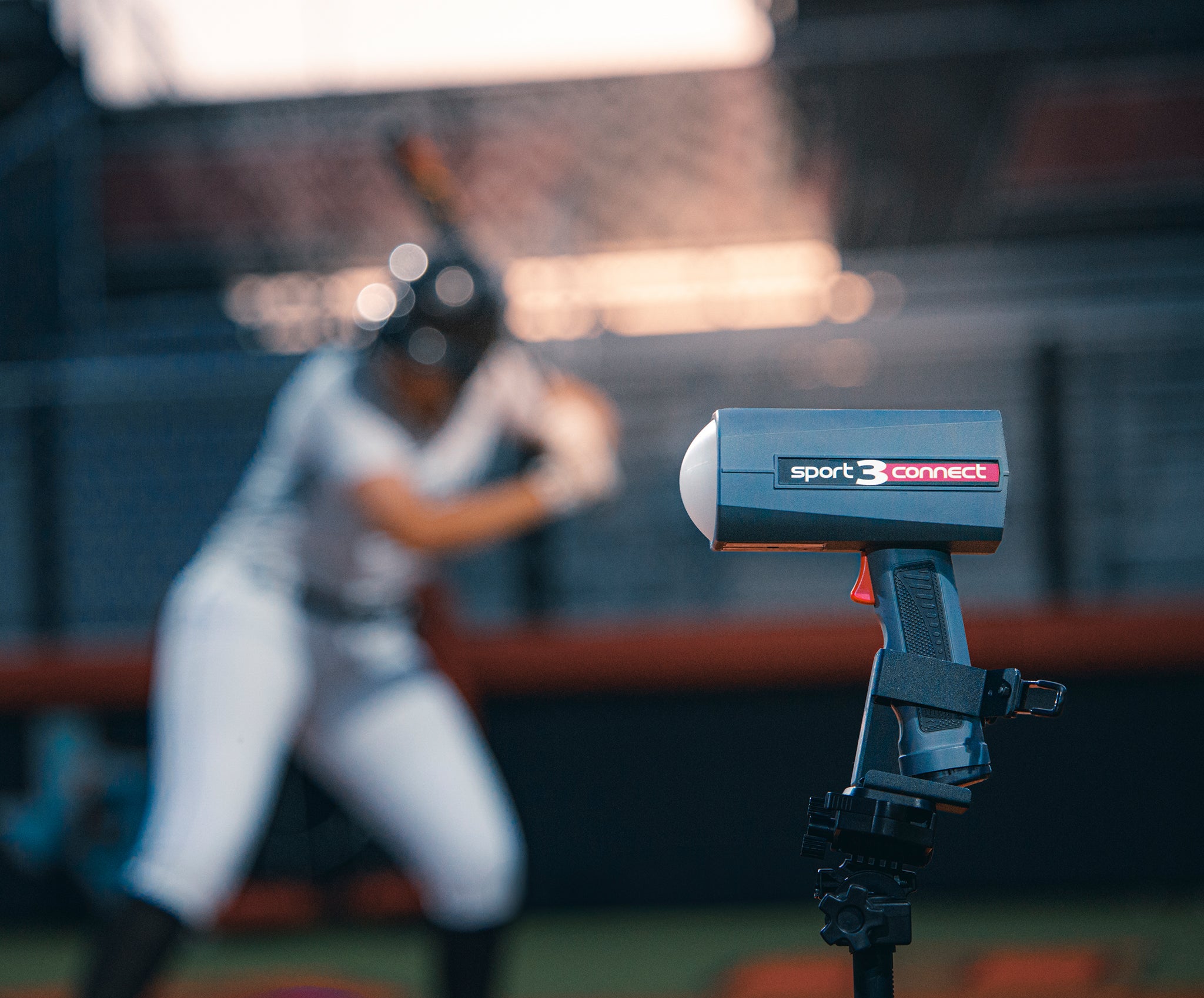 A Sport 3 Connect on a tripod with a softball batter from Team Stalker Sport in the background.