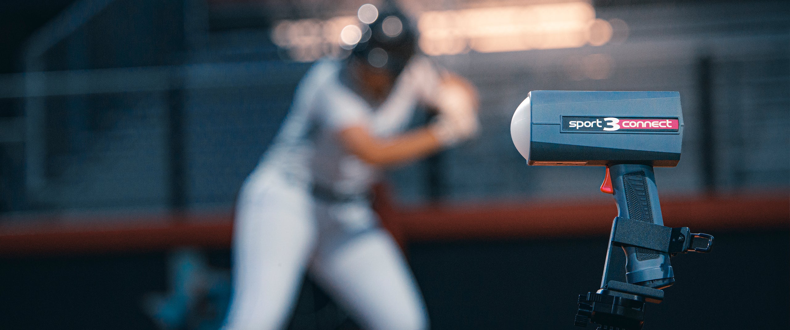 A Sport 3 Connect radar gun mounted to a tripod during a softball game. 