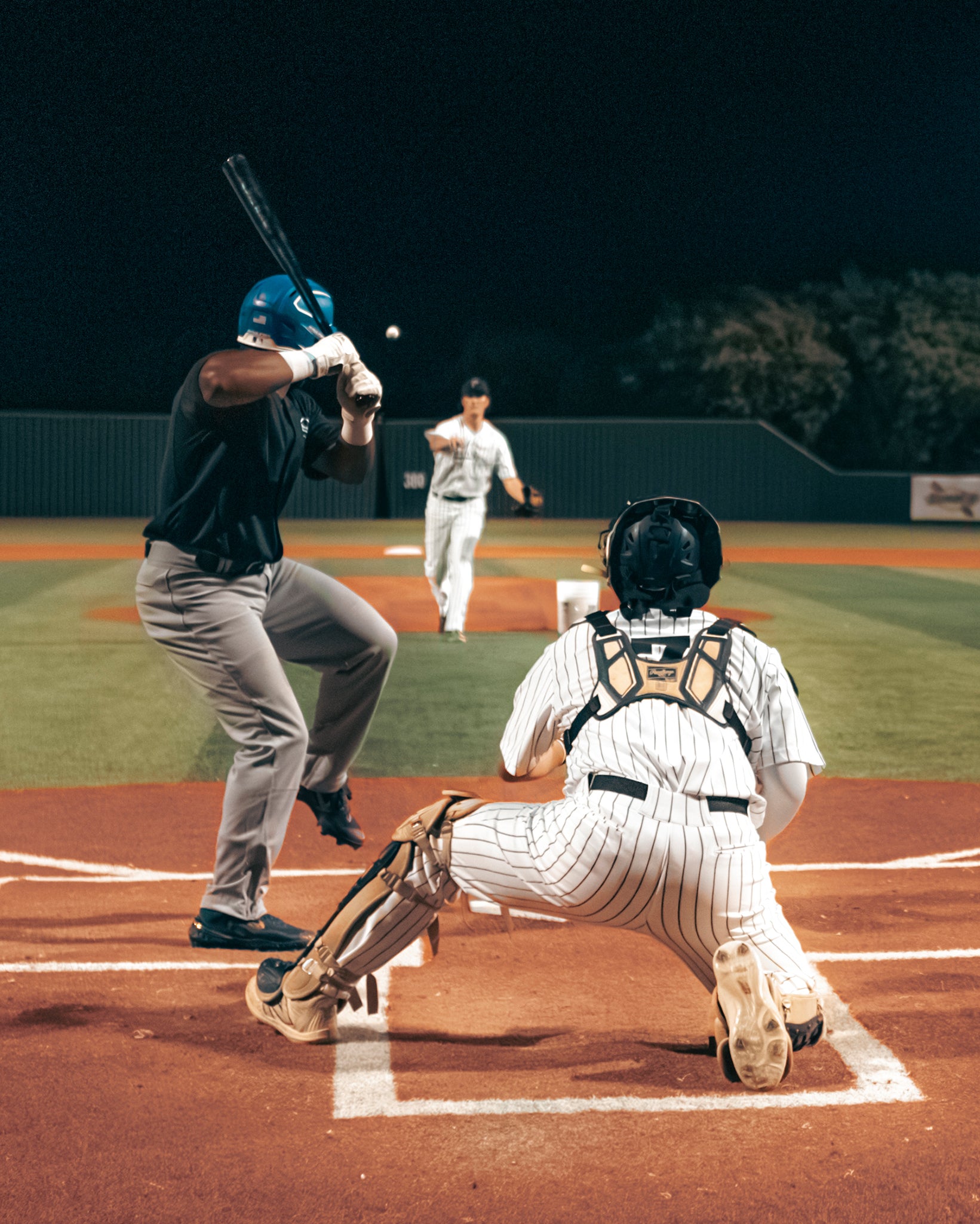 Team Stalker Sport playing baseball at night.