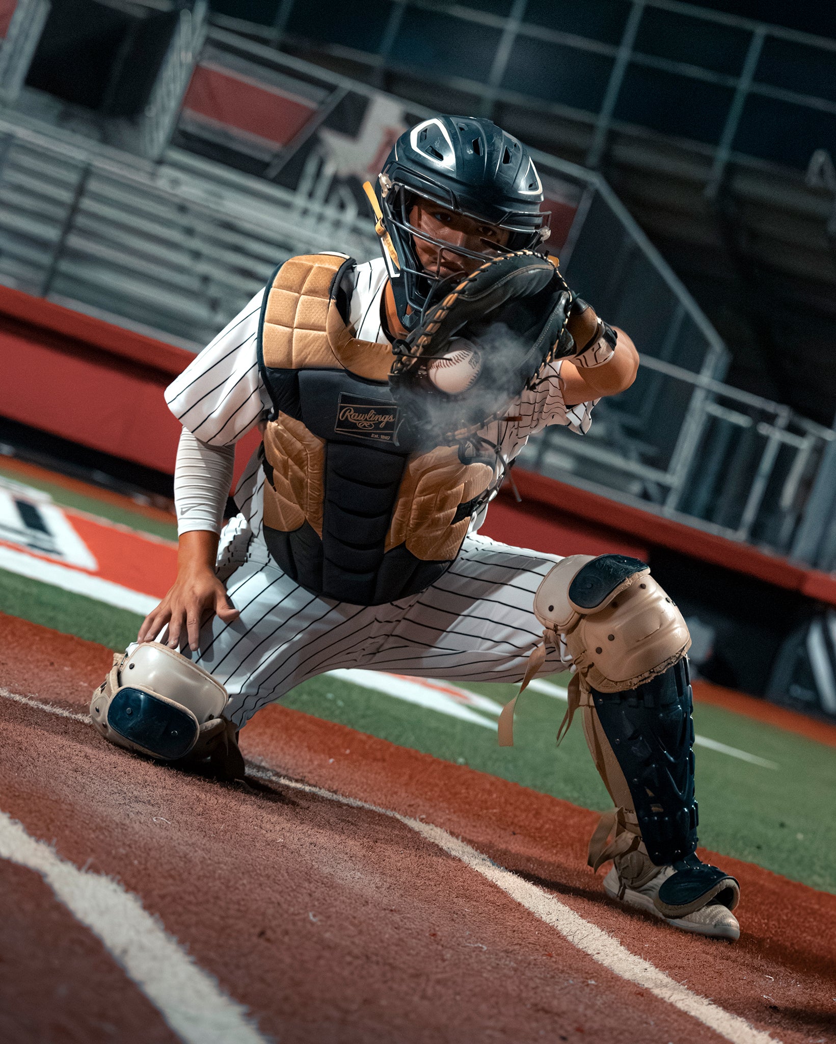 The catcher from Team Stalker Sport catching a baseball.