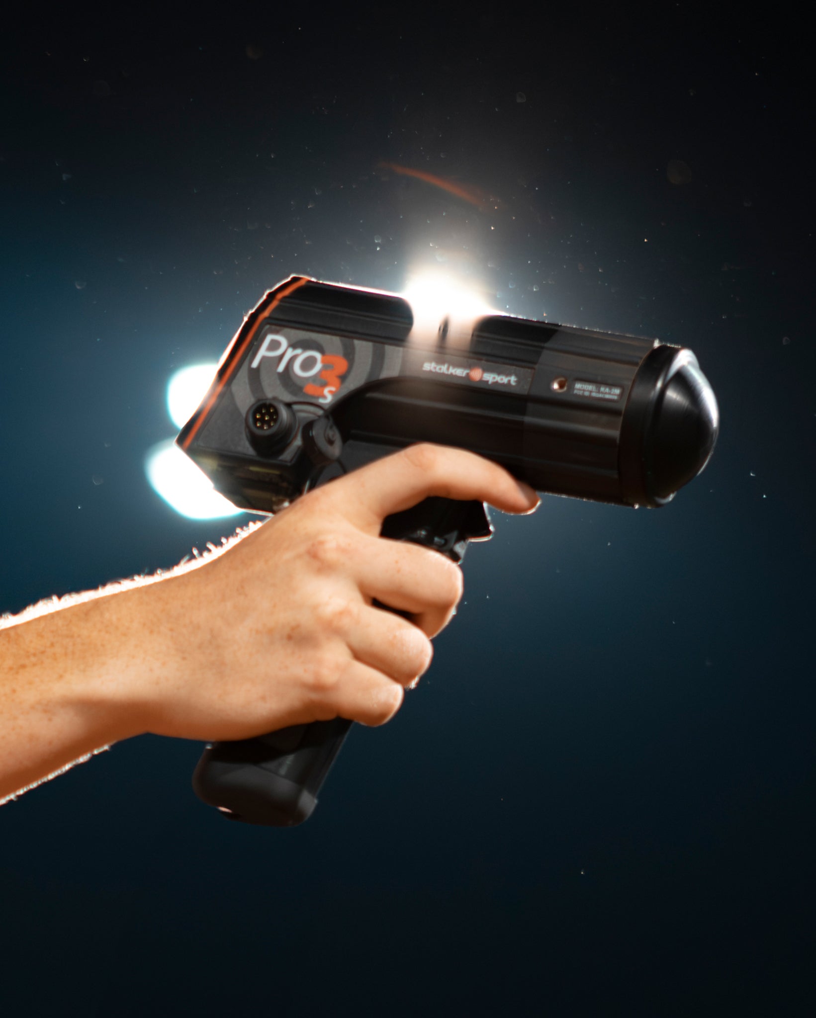 A hand holding a Stalker Sport Pro 3s radar.