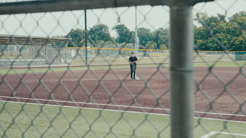 NEW Stalker Sport 3s & Stadium Hub showcased at a baseball field while a player pitches in the background. 