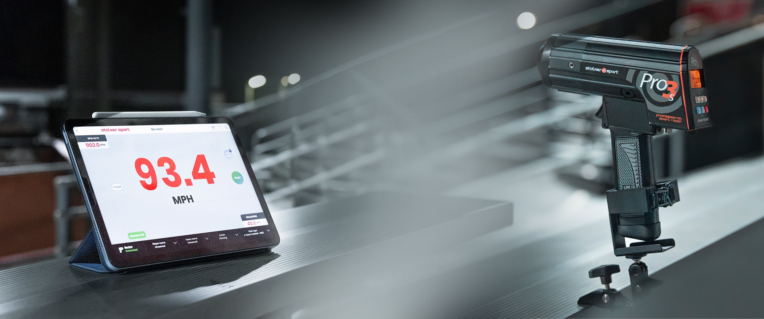 A Pro 3s handheld sports radar in the 4-in-1 mount clamped to a bleacher seat next to an iPad using the Stalker Sport Radar iOS app displaying a speed of 93.4 MPH.