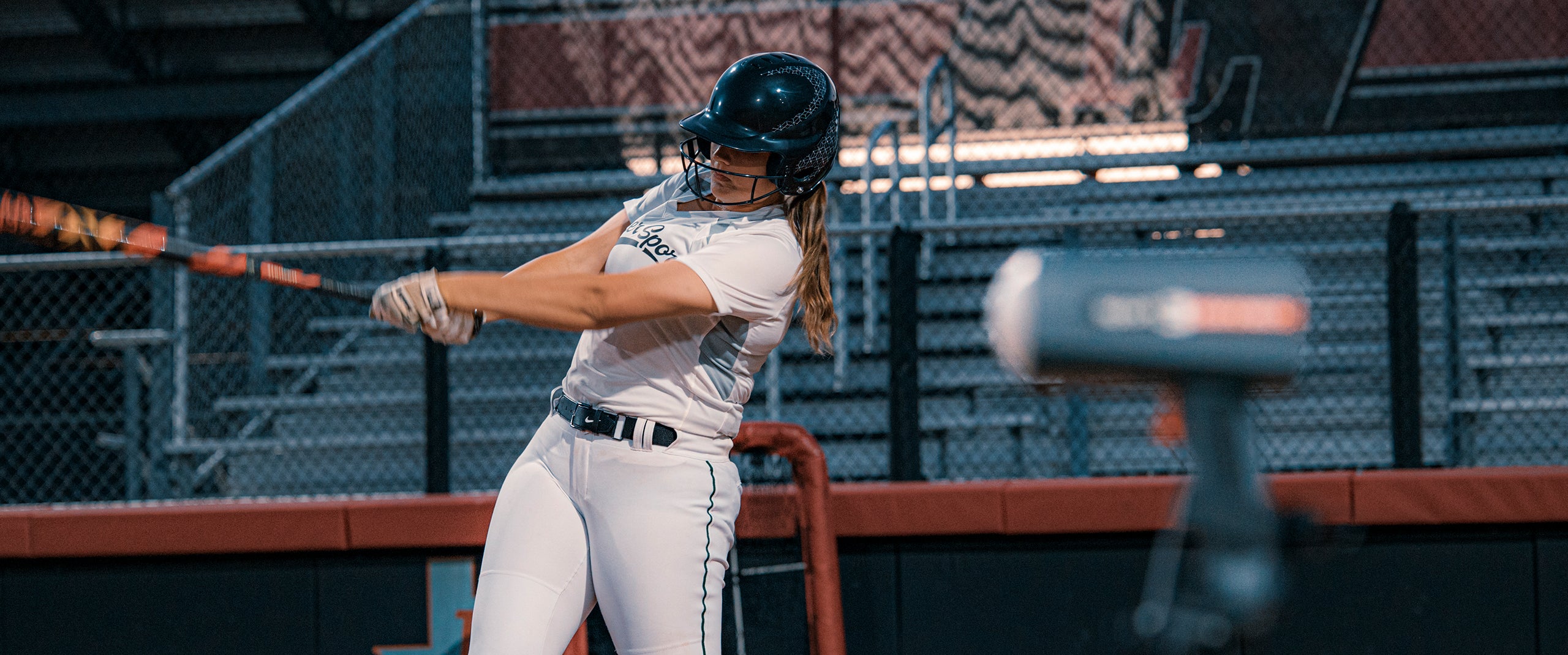 A batter for Team Stalker Sport in mid-swing with an out-of-focus Sport 3 Connect radar in the foreground.