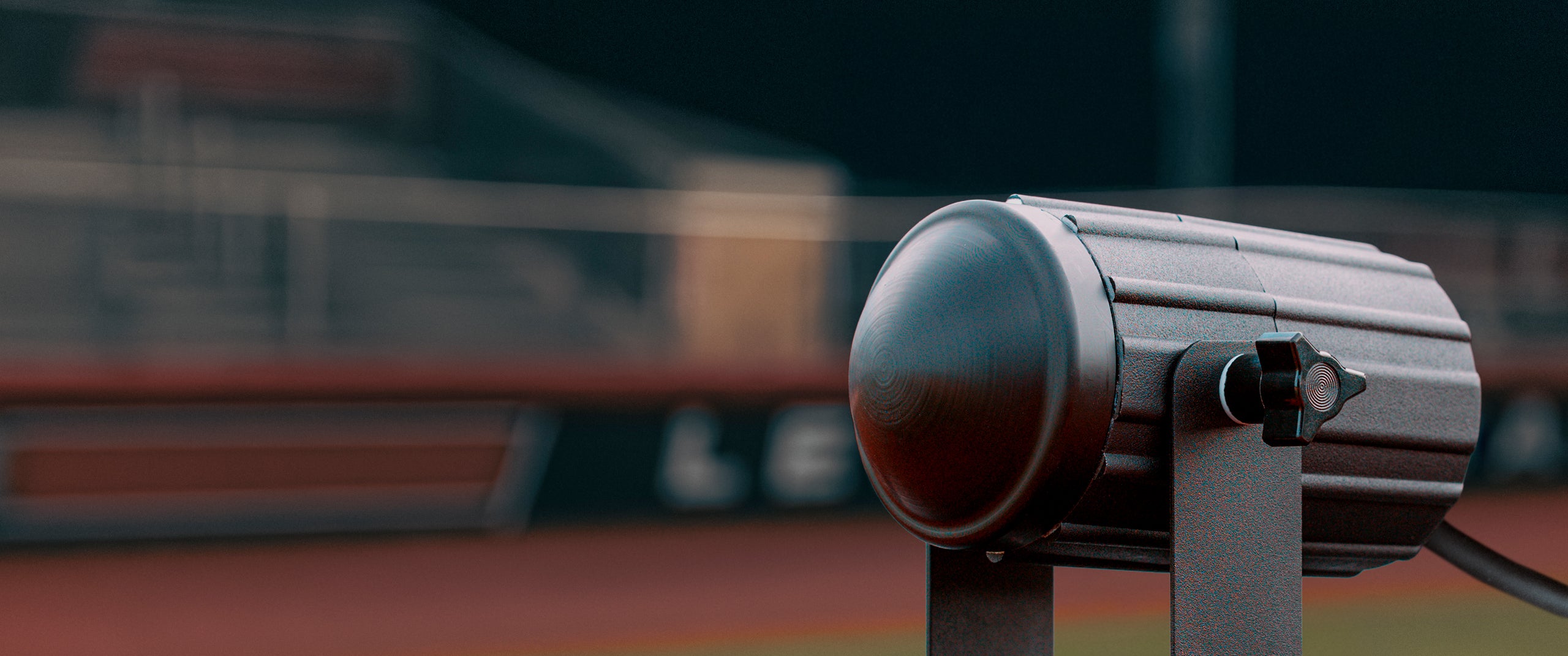A close up of the Stalker Sport Pro II Speed Sensor at a baseball field at night. 