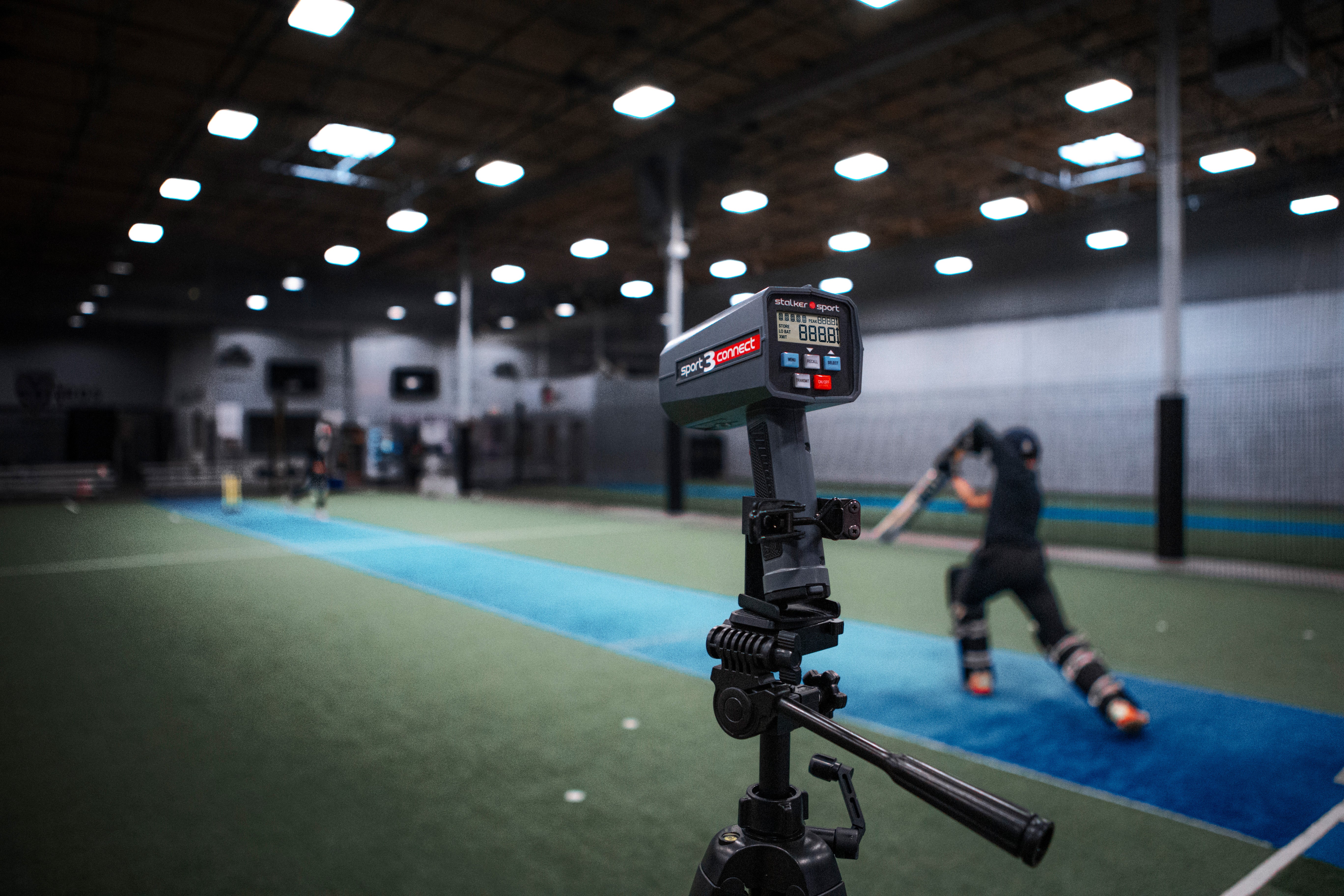 A tripod-mounted Stalker Sport 3 Connect being used during cricket practice.