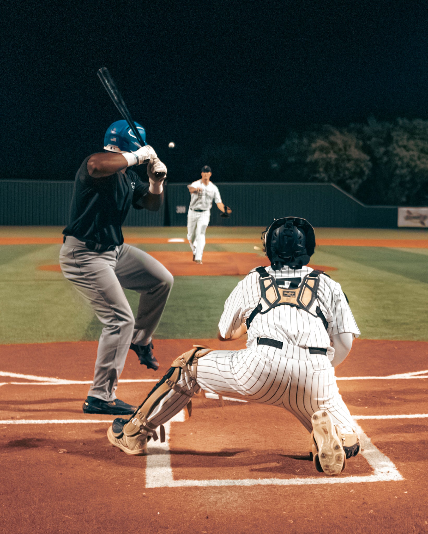Team Stalker Sport playing baseball at night.